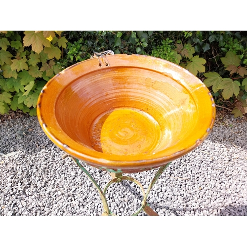 64 - Glazed terracotta bowl raised on metal stand {72 cm H x 52 cm Dia.}.