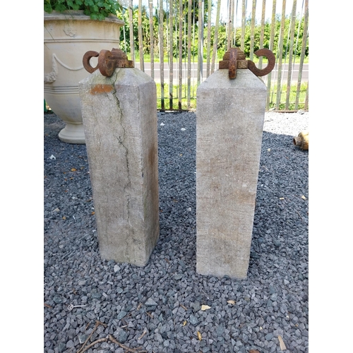 66 - Pair of 19th C. hand-cut limestone bollards with wrought iron tops {72 cm H x 21 cm W x 21 cm D}.