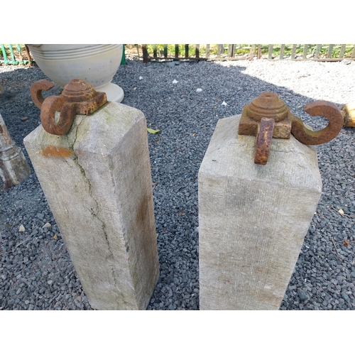 66 - Pair of 19th C. hand-cut limestone bollards with wrought iron tops {72 cm H x 21 cm W x 21 cm D}.