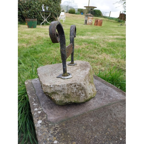 743 - Wrought iron boot pull mounted on stone base {32 cm H x 30 cm W x 24 cm D}.