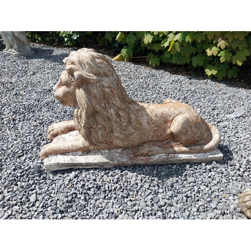 836 - Pair of re-constituted stone statues of recumbent Lions {50 cm H x 87 cm W x 31 cm D}.