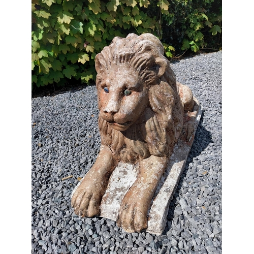 836 - Pair of re-constituted stone statues of recumbent Lions {50 cm H x 87 cm W x 31 cm D}.