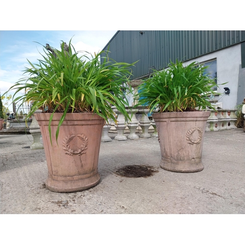 888 - Pair of moulded terracotta planters decorated with rosettes {51 cm H x 50 cm Dia.}.