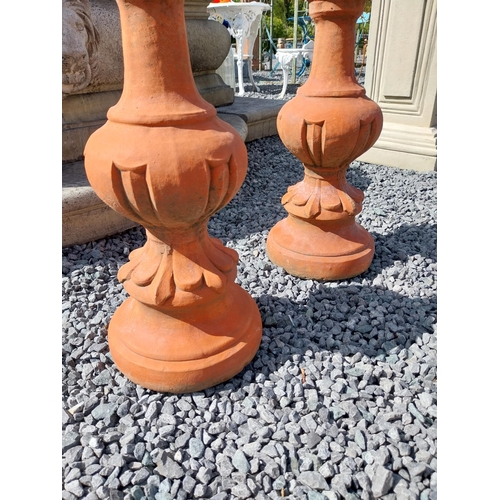 897 - Pair of moulded terracotta finials {74 cm H x 23 cm Dia.}.