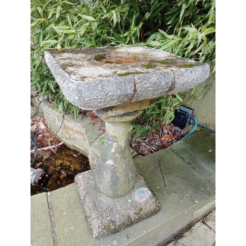 977 - Composition stone bird bath raised on pedestal {H 68cm x W 37cm X D 37 cm }.