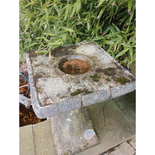 977 - Composition stone bird bath raised on pedestal {H 68cm x W 37cm X D 37 cm }.