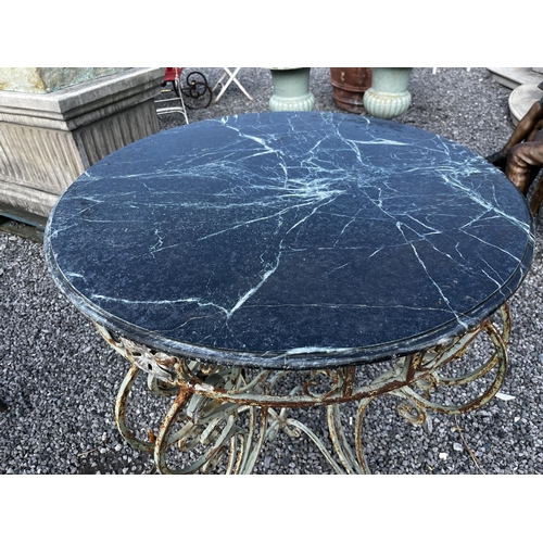 33 - Decorative wrought iron garden table with marble top {98cm H x 87cm Dia.}