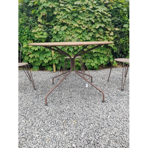 169A - Wrought iron garden table with four matching chais.