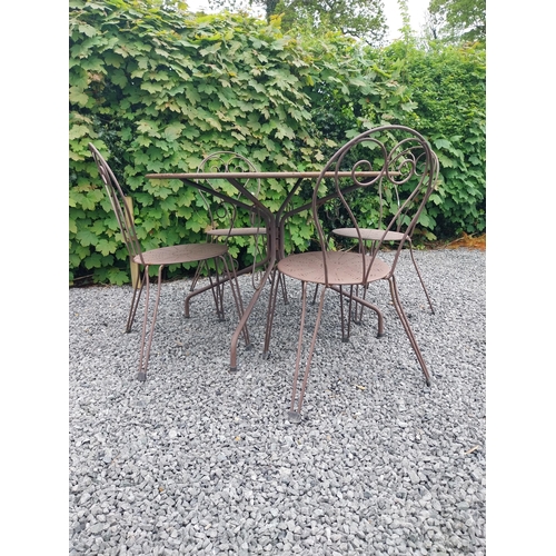 169A - Wrought iron garden table with four matching chais.