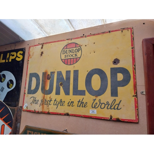 1057 - Dunlop Stock First Tyre in the World enamel advertising sign. {50 cm H x 75 cm W}.