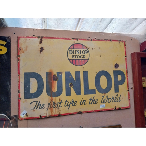 1057 - Dunlop Stock First Tyre in the World enamel advertising sign. {50 cm H x 75 cm W}.