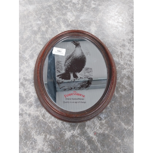 1061 - Famous Grouse Scotch Whiskey framed oval advertising mirror. {29 cm H x 23 cm W}.