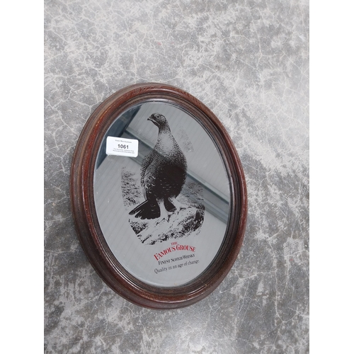 1061 - Famous Grouse Scotch Whiskey framed oval advertising mirror. {29 cm H x 23 cm W}.