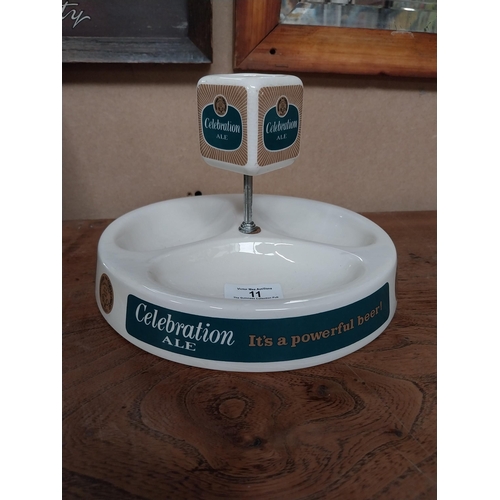 11 - Celebrations Ale ceramic advertising Ashtray and match strike by Wade. {14 cm H x 21 cm Dia.}.