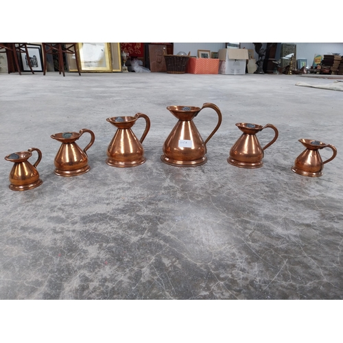 1115a - Set of six graduated copper measures. {17 cm H x 14 cm Dia. to 7 cm H x 8 cm Dia.}.