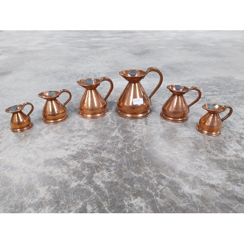 1115a - Set of six graduated copper measures. {17 cm H x 14 cm Dia. to 7 cm H x 8 cm Dia.}.