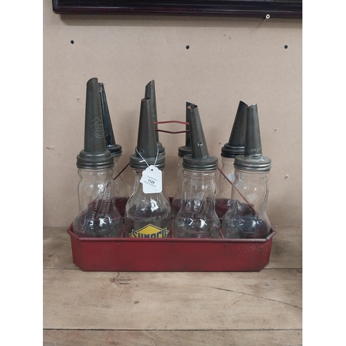 1129 - Rare collection of eight American oil bottles in metal carry crate. {26 cm H x 43 cm W x 21 cm D}.