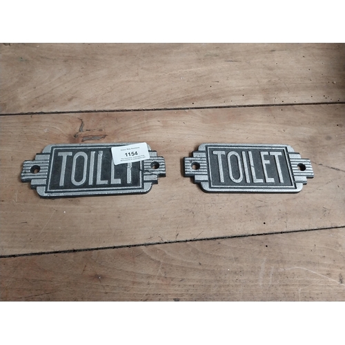 1154 - Two cast iron Toilet signs. {6 cm H x 14 cm W}.