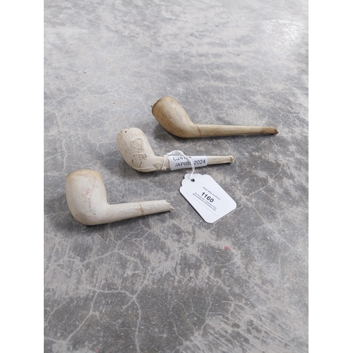 1160 - Three 19th C. clay pipes. {4 cm H x 11 cm W}.