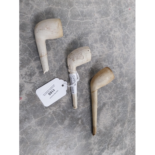 1160 - Three 19th C. clay pipes. {4 cm H x 11 cm W}.