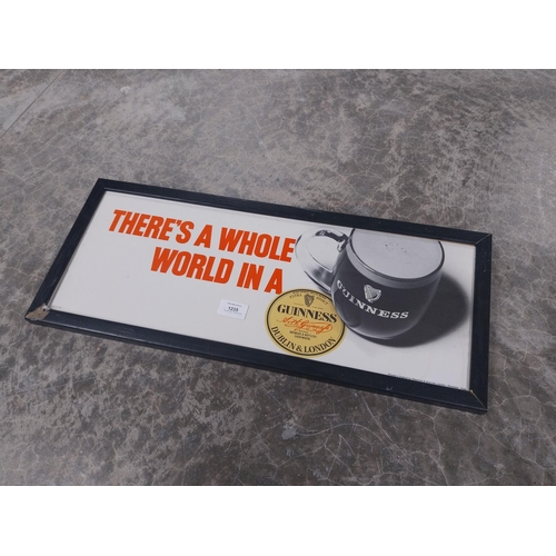 1235 - There's a Whole World in a Guinness framed showcard. {24 cm H x 49 cm W}.