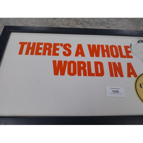 1235 - There's a Whole World in a Guinness framed showcard. {24 cm H x 49 cm W}.