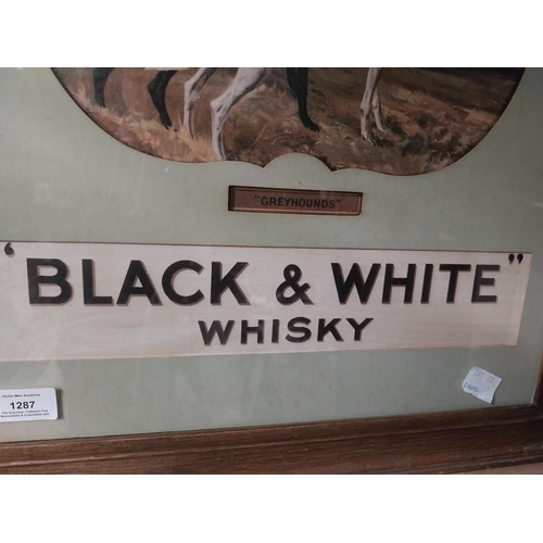 1287 - Black and White Scotch Whiskey framed advertising print. {59 cm H x 50 cm W}.