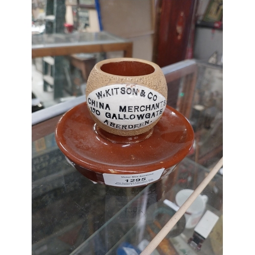 1295 - W Kitson and Co China Merchants Gallowgate Aberdeen ceramic match strike. {8 cm H x 10 cm Dia.}