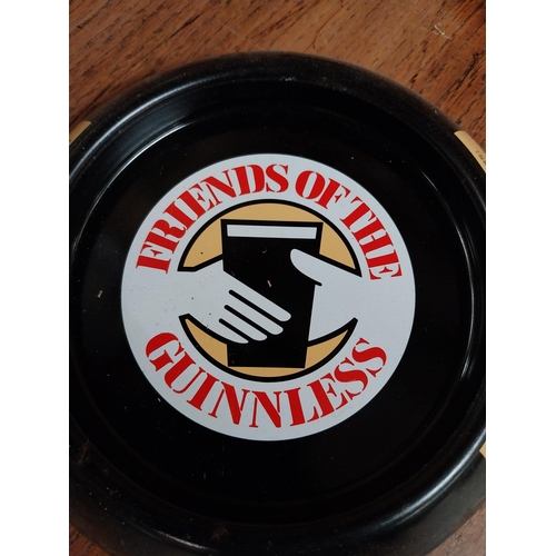 130 - Five tinplate Friends of the Guinness advertising ashtrays. {3 cm H x 15 cm D}