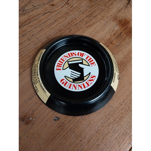 130 - Five tinplate Friends of the Guinness advertising ashtrays. {3 cm H x 15 cm D}