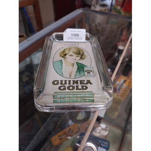 1300 - Ogden's Guinea Gold glass ashtray. {15 cm H x 9 cm W}.