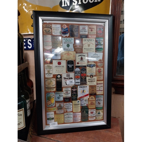 135 - Framed montage  print of Irish and Scotch Whiskey labels. {50 cm H x 37 cm W}.