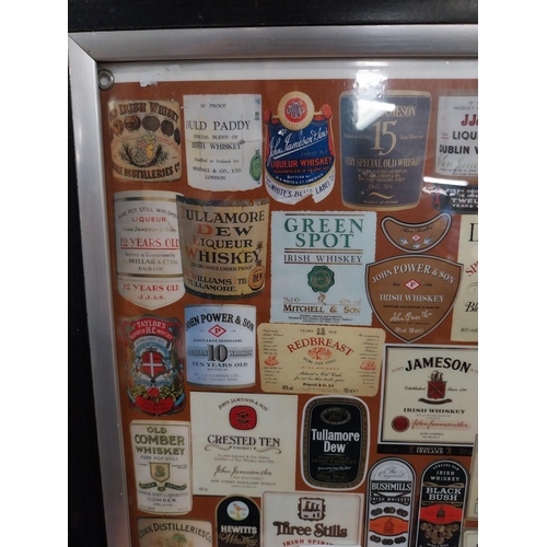 135 - Framed montage  print of Irish and Scotch Whiskey labels. {50 cm H x 37 cm W}.