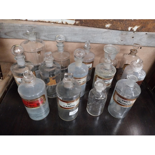 1386 - Fifteen 19th C. glass chemist bottles, some with labels. {18 cm H} approx.