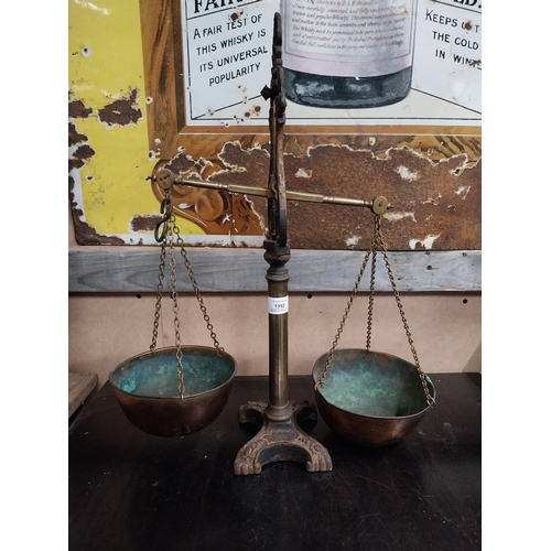 1392 - Early 20th C. brass and cast iron shop scales. {54 cm H x 43 cm W x 19 cm D}.