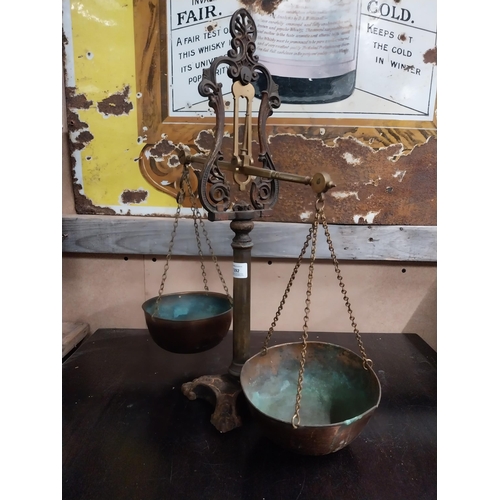 1392 - Early 20th C. brass and cast iron shop scales. {54 cm H x 43 cm W x 19 cm D}.