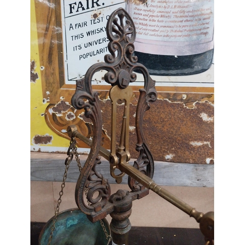 1392 - Early 20th C. brass and cast iron shop scales. {54 cm H x 43 cm W x 19 cm D}.