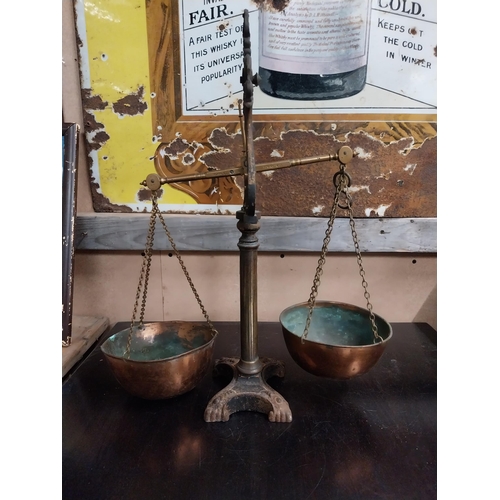 1392 - Early 20th C. brass and cast iron shop scales. {54 cm H x 43 cm W x 19 cm D}.