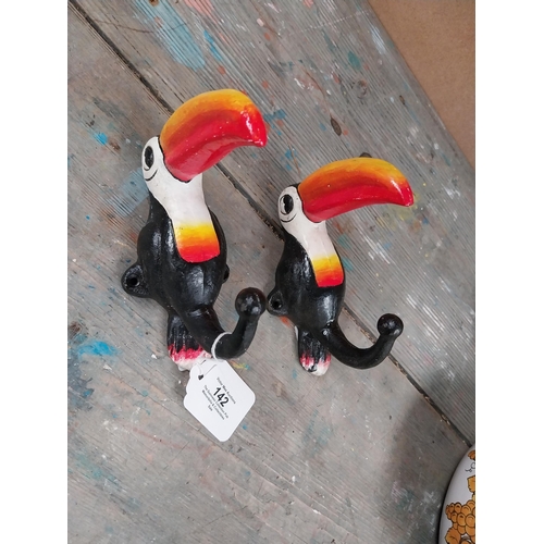 142 - Cast iron Toucans in the form of coat hangers. {16 cm H x 7 cm W}.