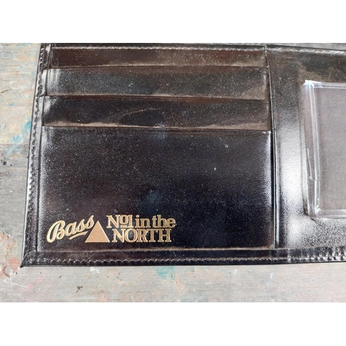 143 - Bass wallet. {10 cm H x 32 cm W}.