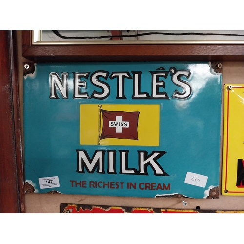 147 - Nestle's Swiss Milk enamel advertising sign. {24 cm H x 36 cm W}.