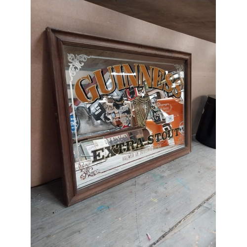 166 - Framed Guinness Extra Stout advertising mirror. {34 cm H x 47 cm W}.