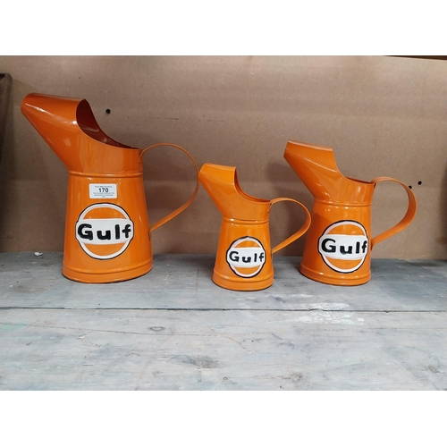 170 - Gulf Petrol tinplate graduated measuring jugs. {27 cm H x 35 cm W x 14 cm D}, {18 cm H x 18 cm W x 1... 