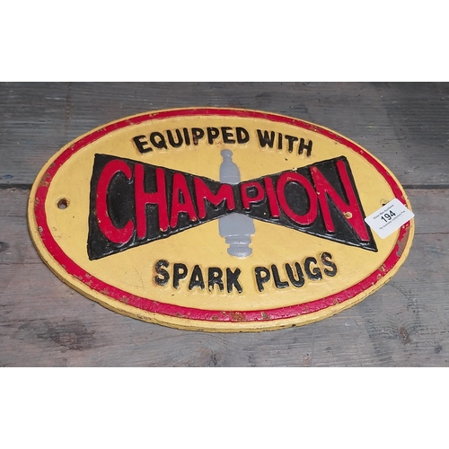 194 - Cast Iron Champion Spark Plugs advertising sign. {20 cm H x 29 cm W}.