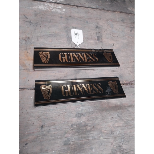 197 - Two Guinness plastic shelf signs. {14 cm W x 4 cm D}.