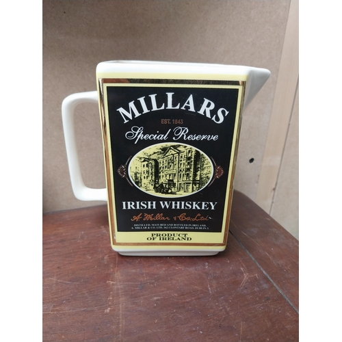 212 - Dunvilles Whiskey Shamrock Lady and Millar's Irish Whiskey ceramic water jugs {15 cm H x 15 cm W x 8... 