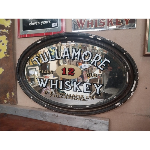 295 - Framed Tullamore Whiskey D E Williams Tullamore oval advertising mirror. {50 cm H x 78 cm W}.