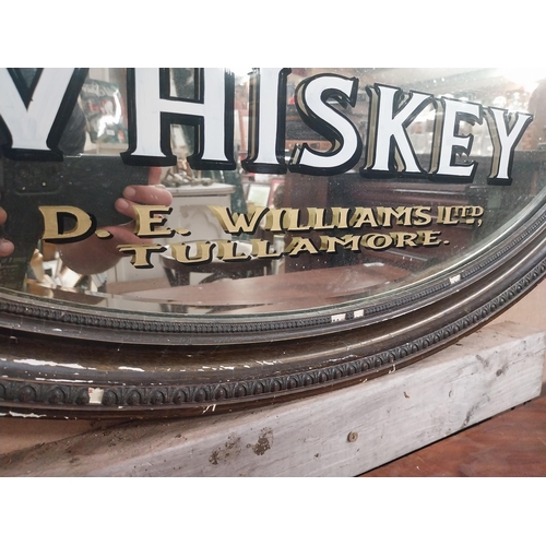 295 - Framed Tullamore Whiskey D E Williams Tullamore oval advertising mirror. {50 cm H x 78 cm W}.