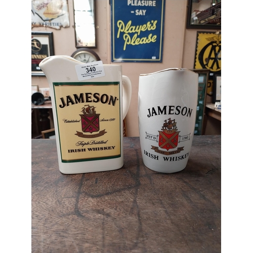 340 - Two Jameson Irish Whiskey ceramic water jugs. {18 cm H x 16 cm W x 10 cm D} and {16 cm H x 11 cm W x... 