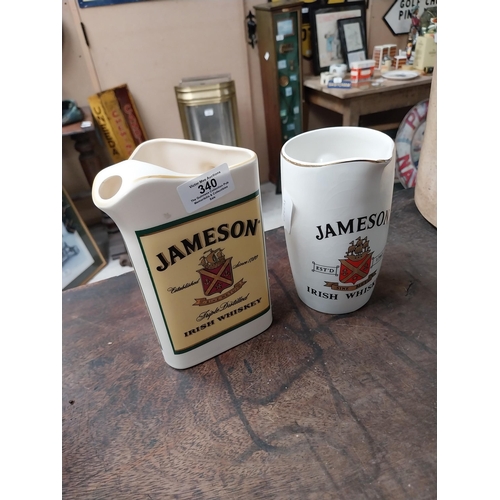 340 - Two Jameson Irish Whiskey ceramic water jugs. {18 cm H x 16 cm W x 10 cm D} and {16 cm H x 11 cm W x... 